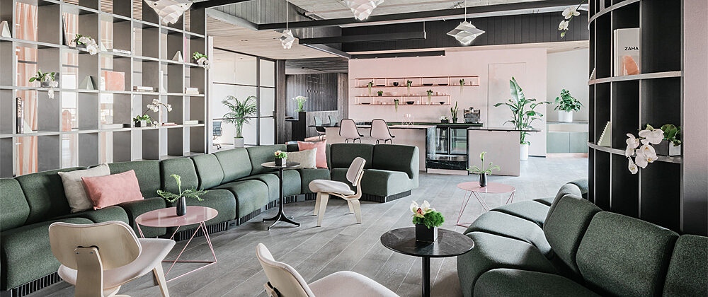 Canopy Jackson Square project showing a living room with green couches and blush accents