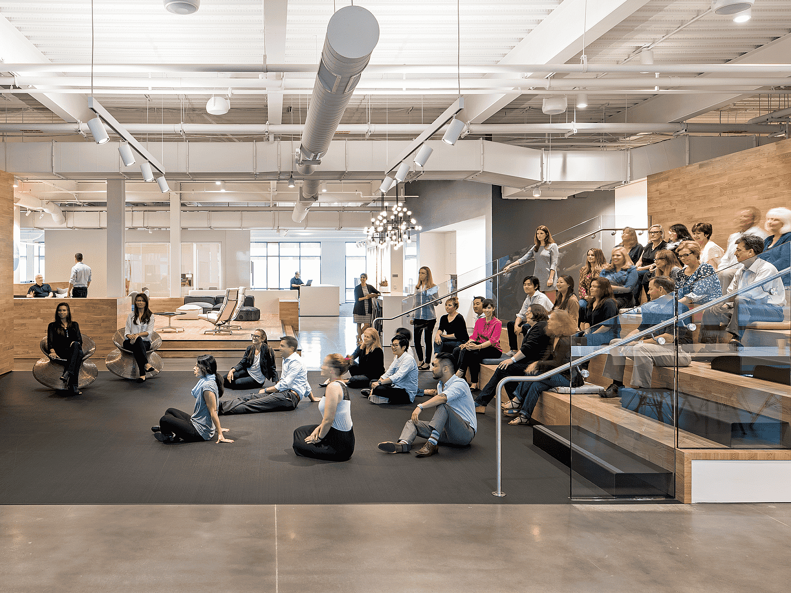 image of employees sitting on bleachers