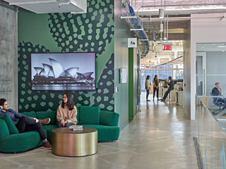 ARUP hallway entry space with people sitting on couch talking