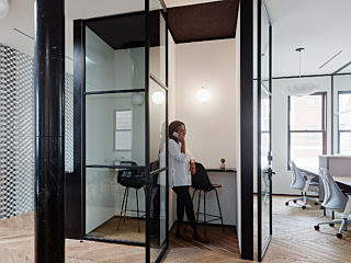 Image of a small breakout pod with woman on the phone