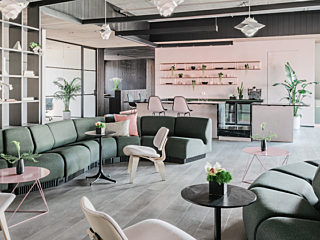 Canopy Jackson Square project showing a living room with green couches and blush accents