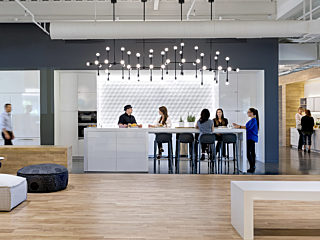 Plaza area in office where people are gathered to eat an connect